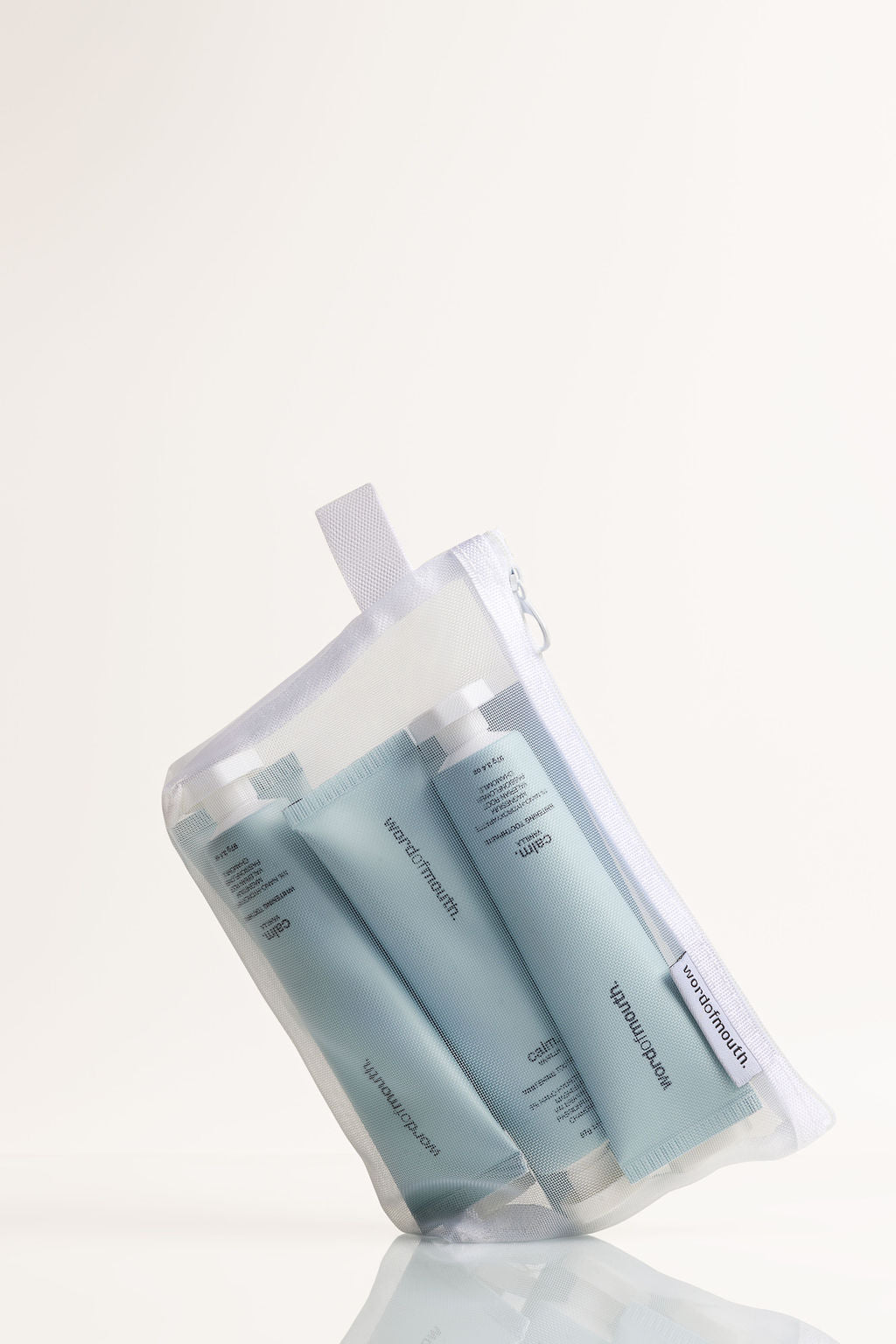Word of Mouth whitening toothpaste travel kit with tubes in a mesh pouch