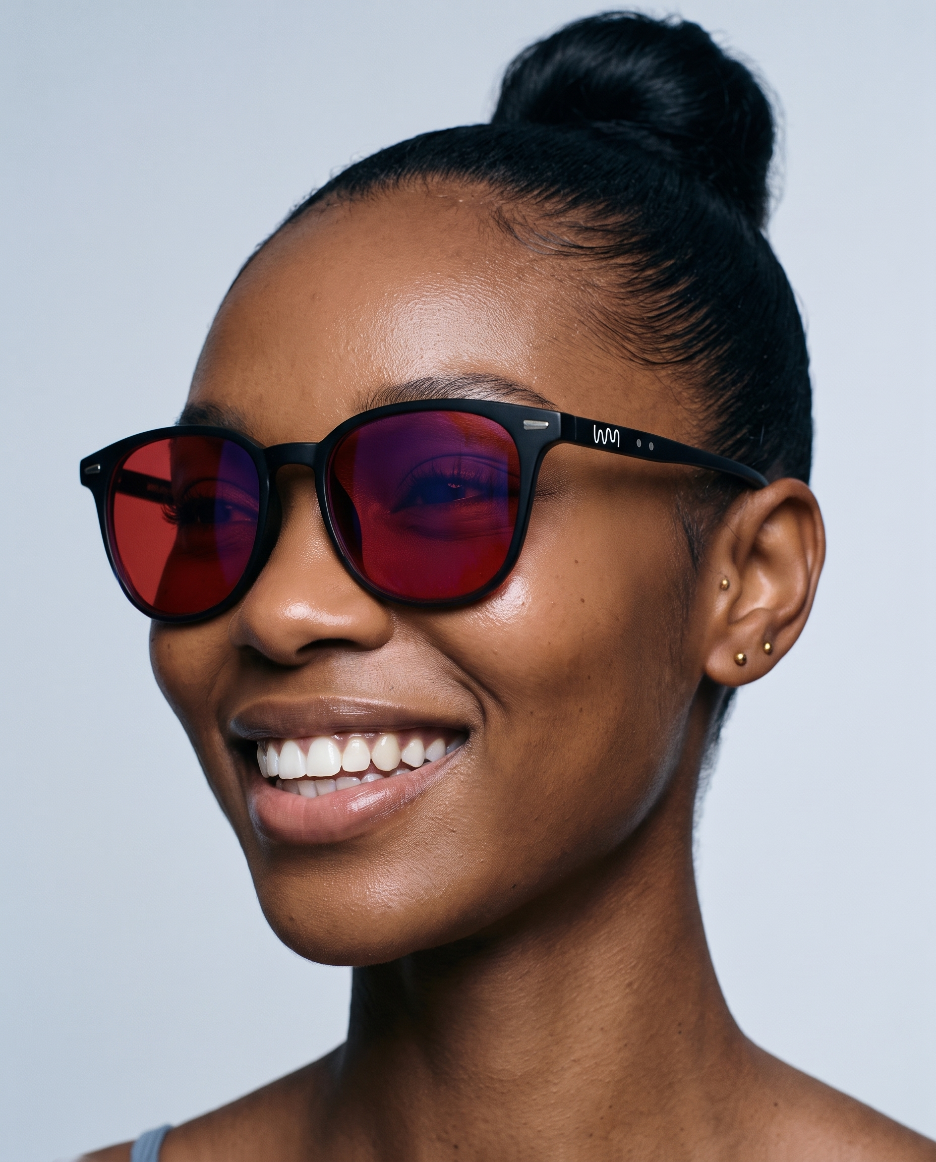Woman laughing while wearing Word of Mouth Blue Light Blockers, close-up