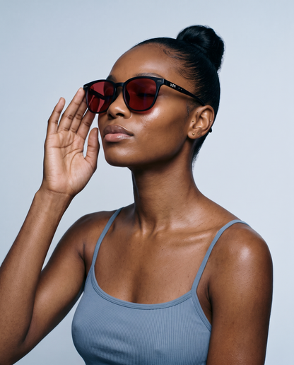 Woman wearing Blue Light Blockers, serene three-quarter portrait