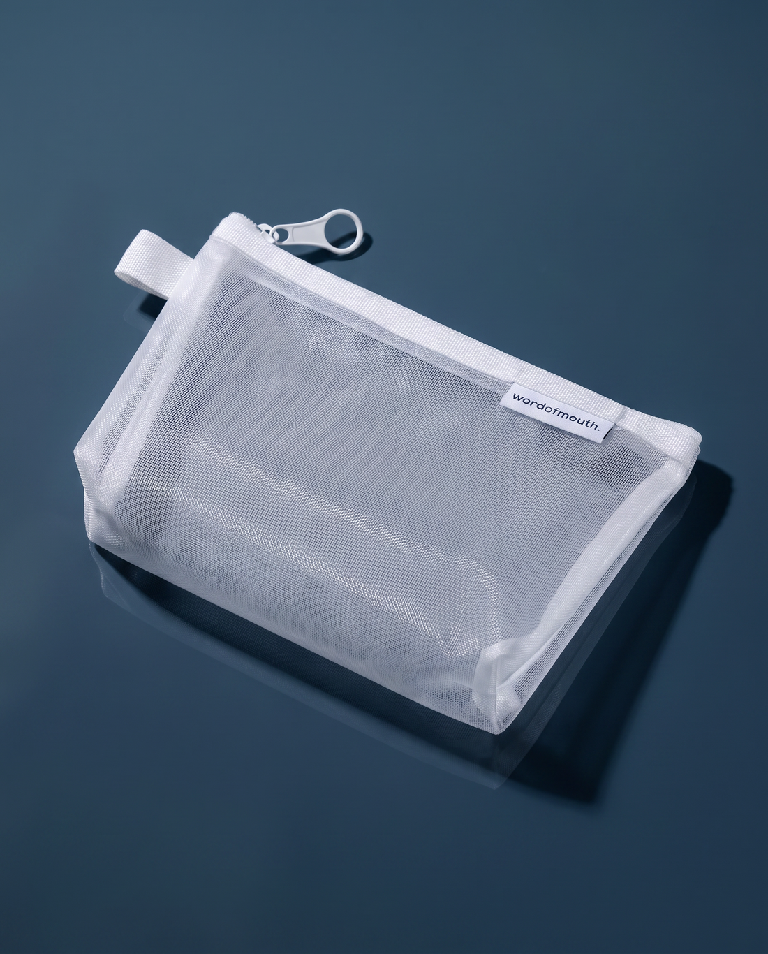 Word of Mouth Essentials Case shown at an angle, showing the white zip and breathable mesh panel